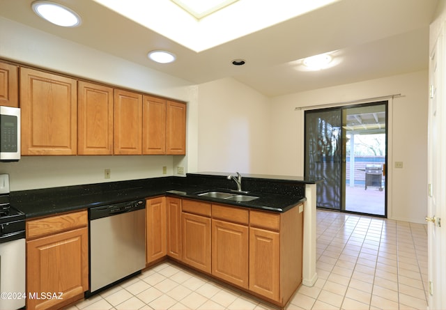 kitchen featuring light tile patterned flooring, kitchen peninsula, sink, white appliances, and dark stone countertops