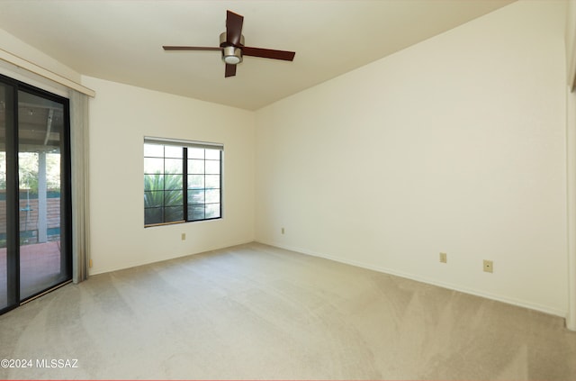 spare room with ceiling fan and light carpet