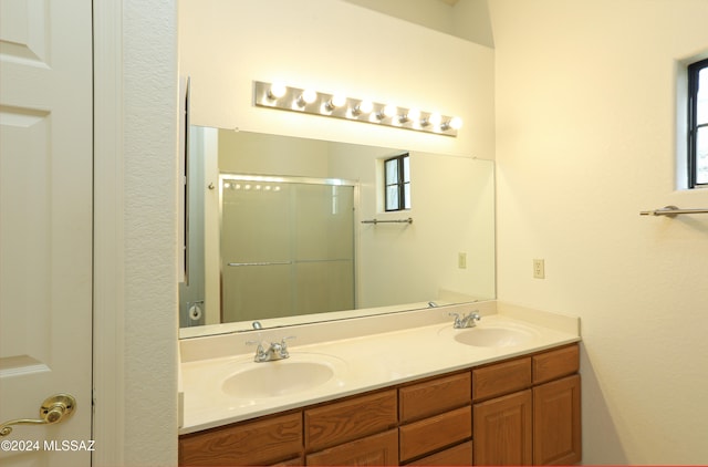 bathroom with vanity and a shower with shower door