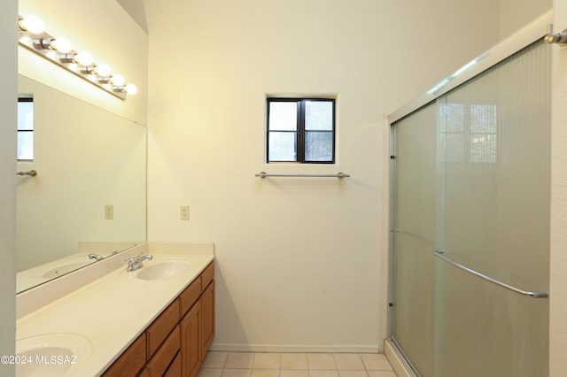 bathroom with tile patterned flooring, an enclosed shower, and vanity