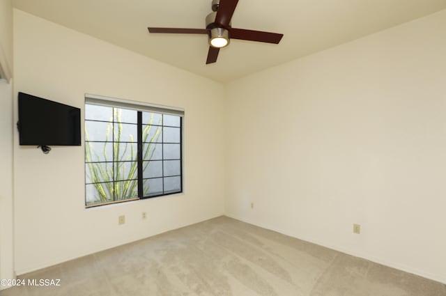 empty room featuring light carpet and ceiling fan