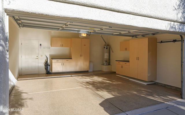 garage featuring gas water heater and a garage door opener