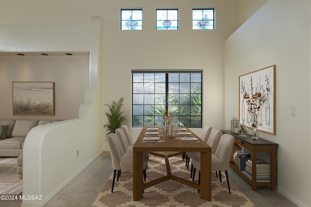 carpeted dining room featuring a wealth of natural light and a towering ceiling