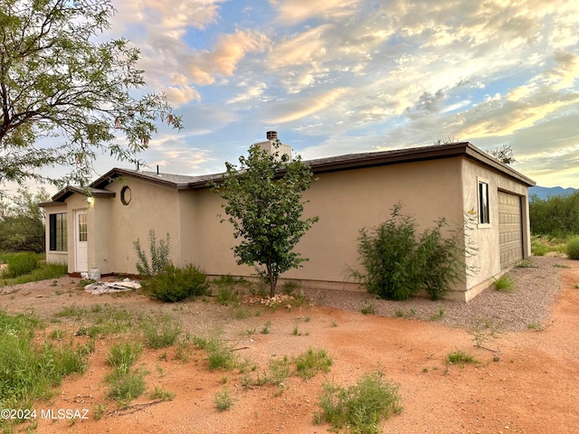 view of side of property featuring a garage