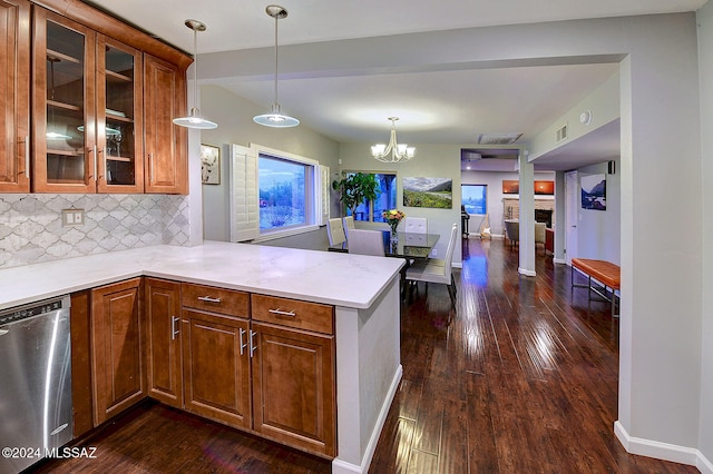 kitchen featuring kitchen peninsula, backsplash, dishwasher, dark wood-type flooring, and pendant lighting