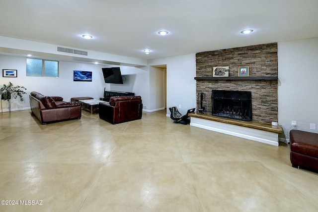 living room featuring a stone fireplace