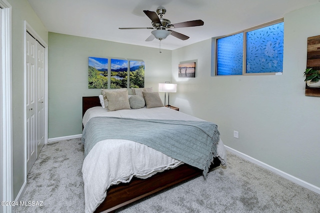 bedroom with light carpet, a closet, and ceiling fan