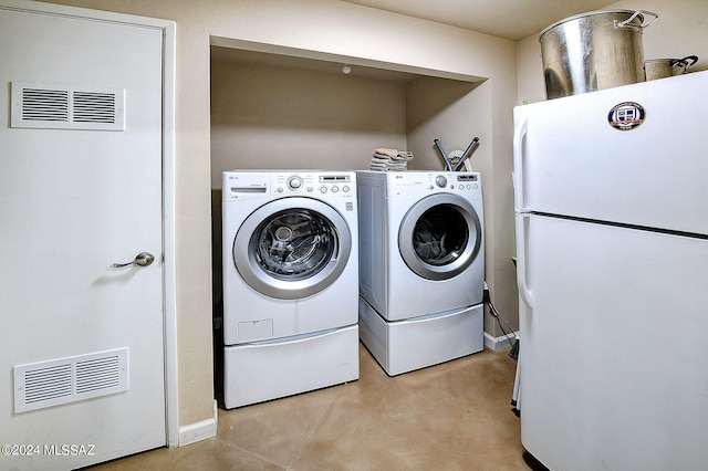 clothes washing area featuring independent washer and dryer