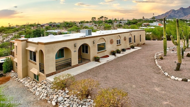 view of front of home with a patio and a mountain view