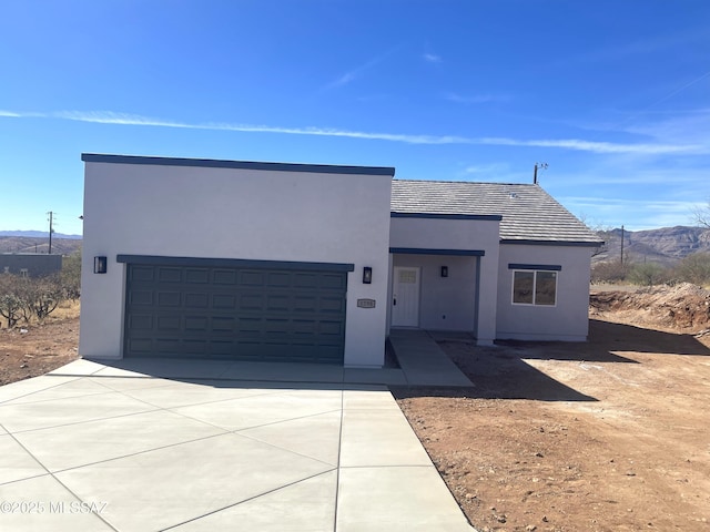 view of front of property with a mountain view and a garage