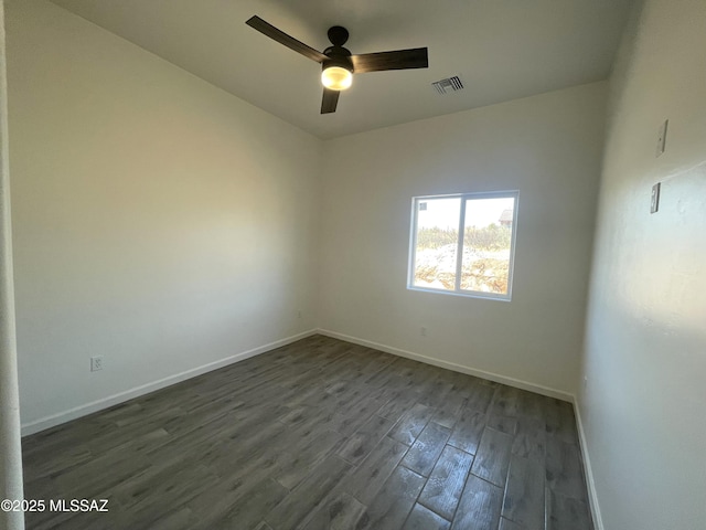 empty room featuring ceiling fan and dark wood-type flooring