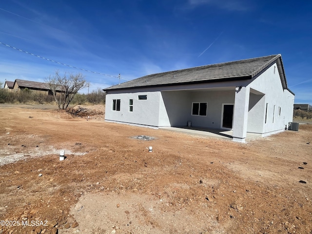 back of property with a patio and central AC unit