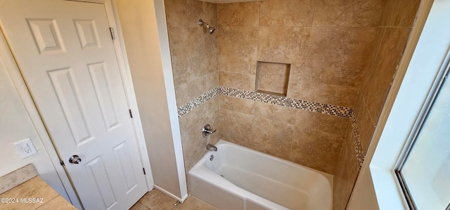 bathroom with tiled shower / bath and tile patterned floors