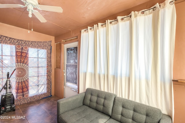 tiled living room with ceiling fan