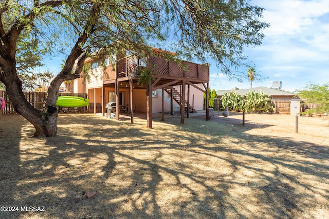 rear view of house featuring a wooden deck