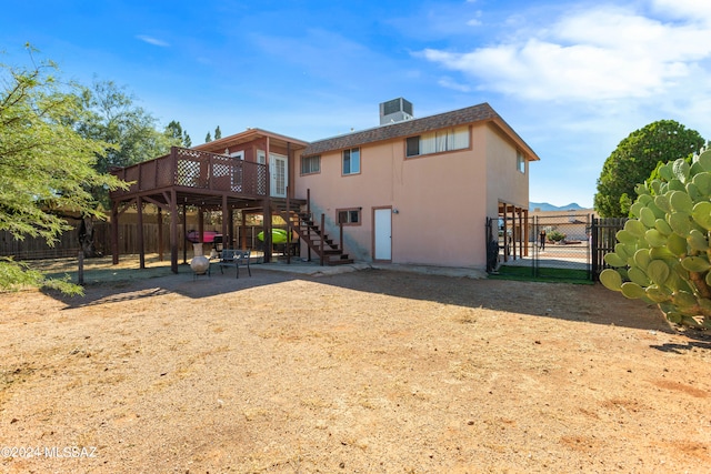 rear view of house featuring a deck and a patio area