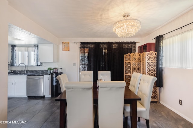 dining space with a notable chandelier and sink