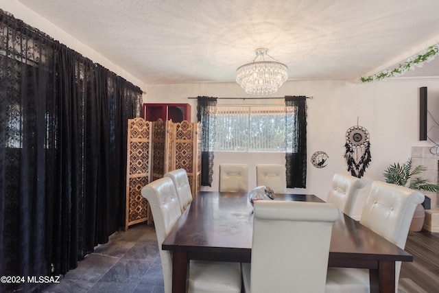 dining space featuring a chandelier and a textured ceiling