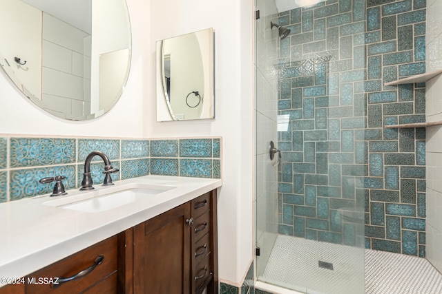 bathroom featuring tile walls, tasteful backsplash, vanity, and an enclosed shower