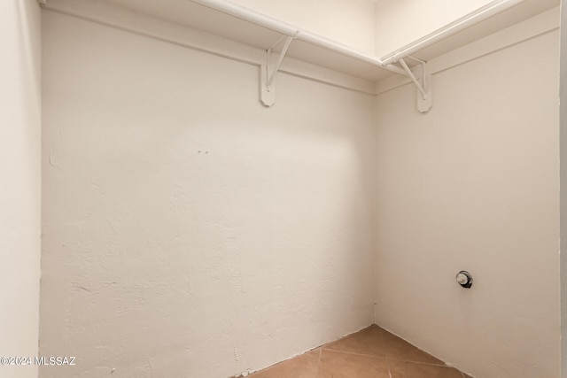 spacious closet featuring tile patterned flooring