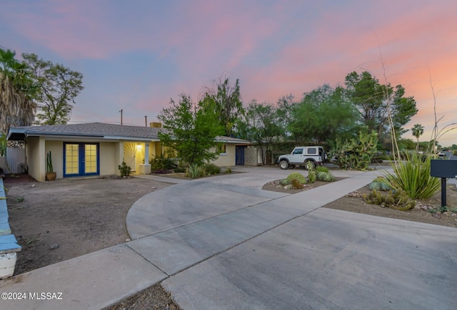5731 E 2nd St, Tucson, AZ 85711 - ranch-style home featuring concrete driveway, stucco siding, and french doors