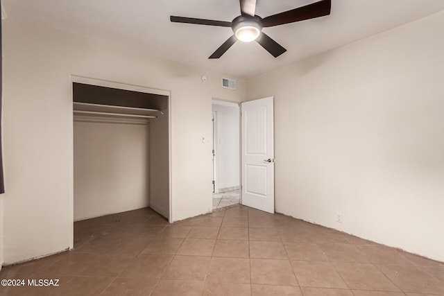 unfurnished bedroom with a closet, ceiling fan, and light tile patterned floors