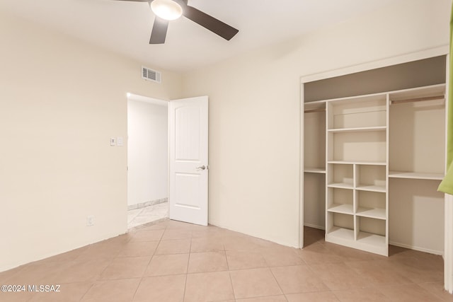 unfurnished bedroom with a closet, ceiling fan, and light tile patterned flooring