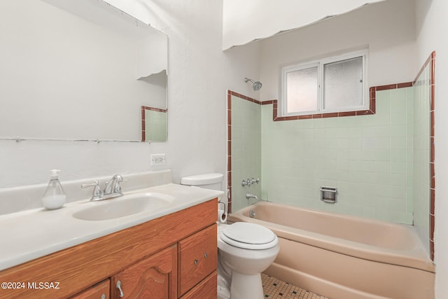 full bathroom featuring tiled shower / bath, vanity, toilet, and tile patterned floors