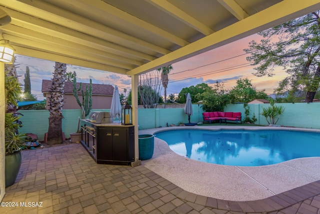 5731 E 2nd St, Tucson, AZ 85711 - pool at dusk featuring an outdoor hangout area, a patio area, a fenced in pool, and a fenced backyard