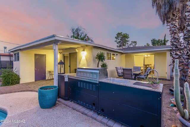 5731 E 2nd St, Tucson, AZ 85711 - view of front facade featuring area for grilling, stucco siding, and a patio
