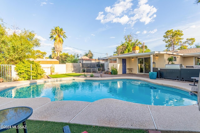5731 E 2nd St, Tucson, AZ 85711 - view of swimming pool with a fenced backyard, a trampoline, a patio, and a fenced in pool