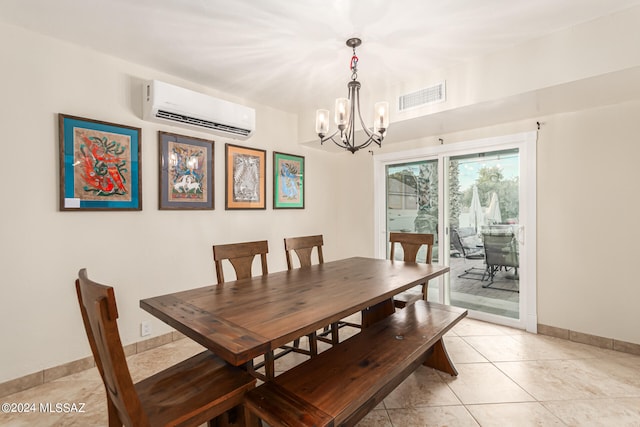 tiled dining room featuring a chandelier and a wall unit AC