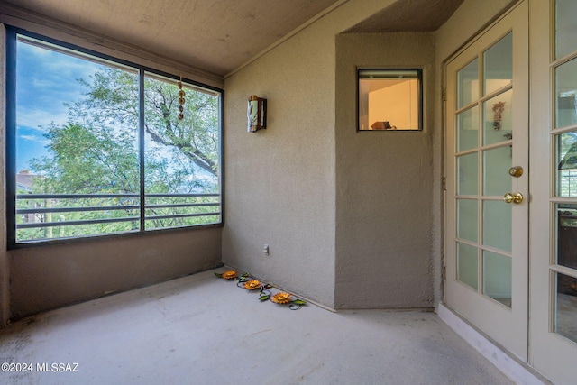 unfurnished sunroom featuring french doors