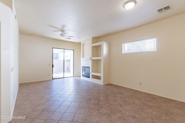 unfurnished living room with light tile patterned floors and ceiling fan