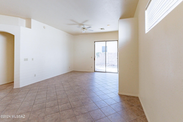 spare room featuring light tile patterned flooring and ceiling fan