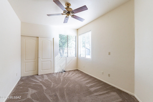 unfurnished bedroom featuring carpet, a closet, and ceiling fan