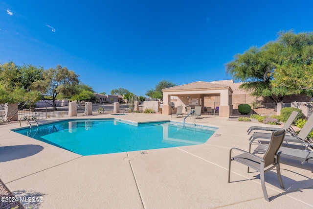 view of swimming pool with a patio area