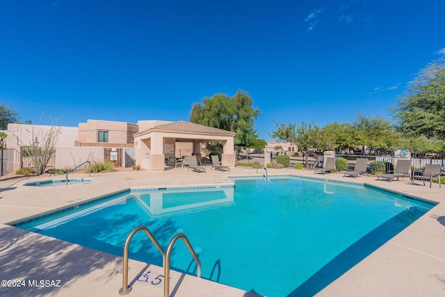 view of swimming pool featuring a patio and a gazebo