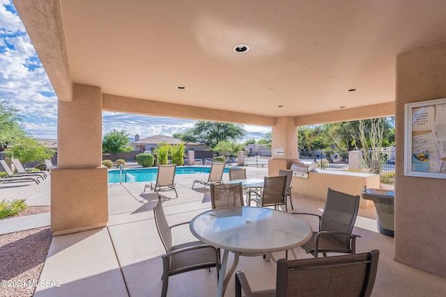 view of patio / terrace featuring a community pool and a grill