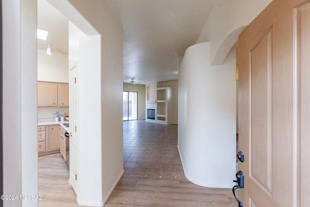 corridor with light hardwood / wood-style floors