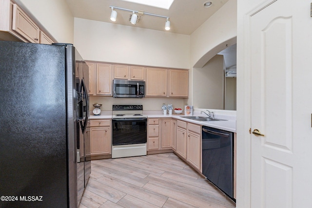 kitchen featuring light hardwood / wood-style flooring, light brown cabinetry, black appliances, and sink