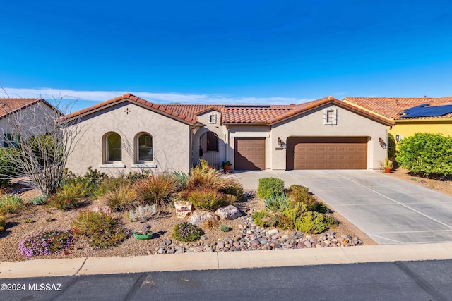 mediterranean / spanish-style home featuring a garage