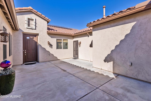 entrance to property with a patio