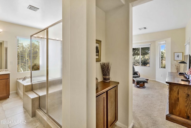 bathroom featuring tile patterned floors, vanity, and independent shower and bath