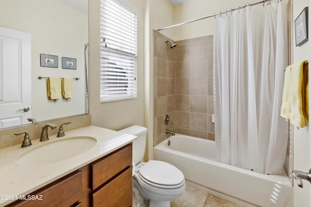 full bathroom featuring tile patterned floors, shower / bath combo with shower curtain, vanity, and toilet