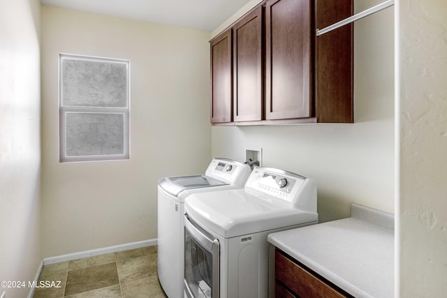 laundry room with cabinets and washing machine and dryer