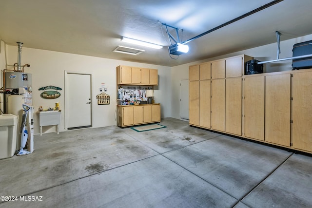 garage with a garage door opener and water heater