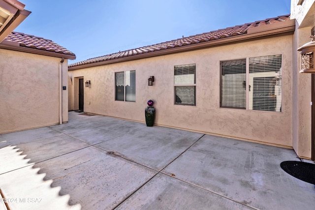 back of property featuring a patio