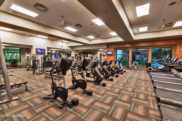 gym with a drop ceiling and carpet floors