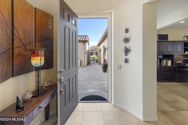 foyer entrance with light tile patterned floors